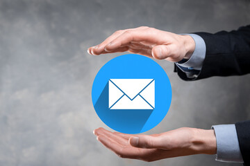 Businessman hand holding letter icon,email icons.Contact us by newsletter email and protect your...