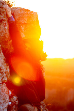 Orange And Yellow Person Climbing While Sunset