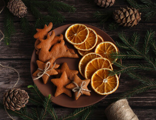 festive ginger cookies in the form of deer and stars with orange slices