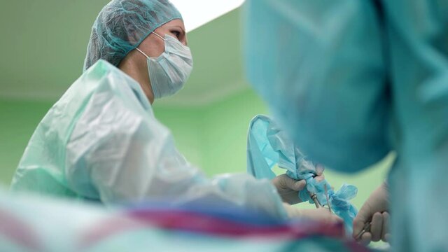 modern endoscopic operation in clinic, female surgeon is curing patient