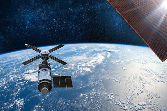 Cargo space craft Earth planet.Dark background. Sci-fi wallpaper.Space Station Orbiting Earth.Space ship.Space art wallpaper.Solar Observatory.Elements of this image furnished by NASA.3D illustration