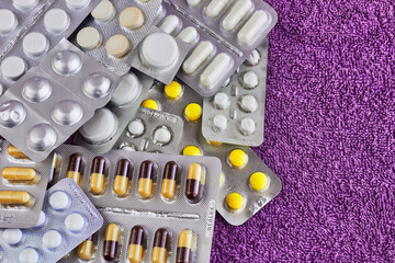 Medical drugs on purple background, for health maintenance, healthcare concept