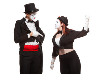Portrait of two mime artists performing, isolated on white background. Woman raised her fist at the...