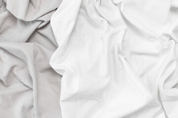Natural linen background. White and grey crumpled natural cotton fabric on light grey background...
