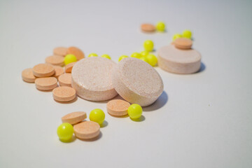 vitamins, pills and medicines are on the table. pills on a white background.