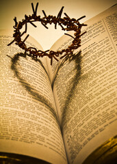 Conceptual image of a bible and a crown of thorns. 