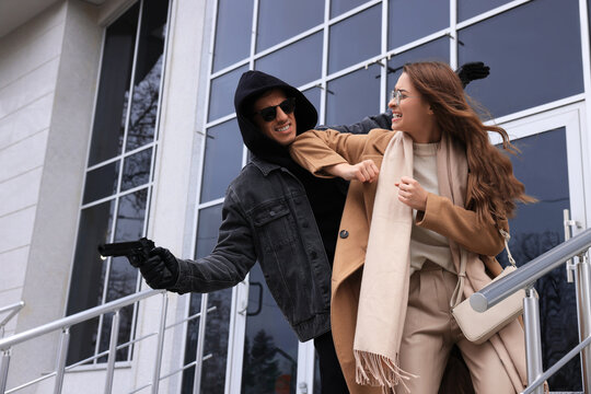 Woman defending herself from attacker near building