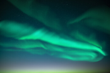 Aurora borealis. Northern lights in winter Finland sky. Sky with polar lights and stars