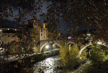 Evening view of Pons Fabricius leading to the island of Isola Tiberina in Rome  - 475319076