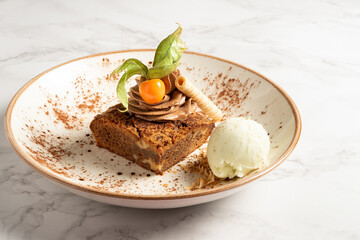 Delicious chocolate brownie dessert served with buttercream ice cream and a rich cocoa cream. Copy Space. High quality photo