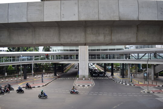 Motorcycle and cars are riding on street at CSW ASEAN integrated station from Trunojoyo street. Jakarta, Indonesia, December 16, 2021