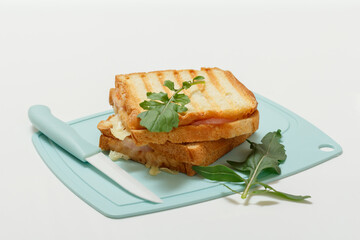 Homemade grilled cheese sandwiches for breakfast on cutting board.