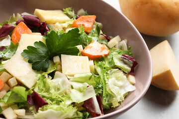 Delicious turnip salad with vegetables and coriander in bowl, closeup