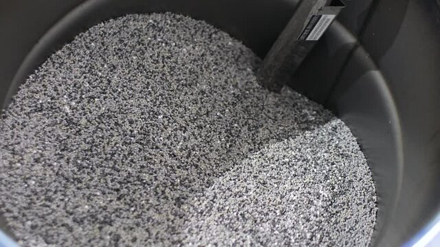 Barrel with polypropylene granules in the technological process. PP Pet Chips Semi Dull, PET chips recycle, PET polyester chips