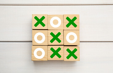 Tic tac toe cube set on white wooden table, flat lay