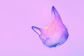 Transparent pink violet plastic bag in violet toned light. High quality photo