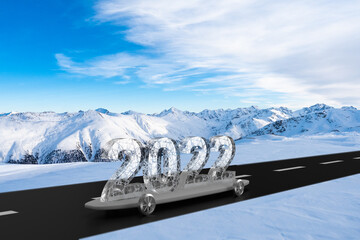 Ice glass 2022 new year car on skateboard and road in mountains winter background.