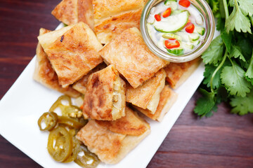 Mutabbaq Roti, Pancakes Stuffed with Beef or fried bread, cut into pieces