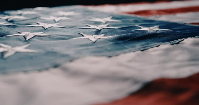 cinematic camera flight along the American flag. American flag detailed in backlit with highly legible stars and stripes