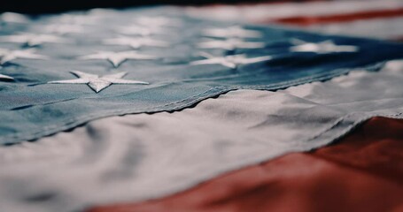 cinematic camera flight along the American flag. American flag detailed in backlit with highly legible stars and stripes