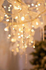 Winter christmas decorations with icicles and branches and lights bokeh