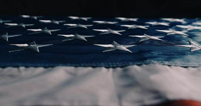 cinematic camera flight along the American flag. American flag detailed in backlit with highly legible stars and stripes