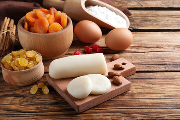 Marzipan and other ingredients for homemade Stollen on wooden table. Baking traditional German Christmas bread