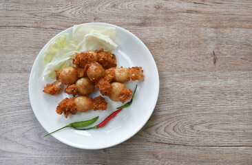 fried Thai northern east sausage stuffed rice and pork eat with fresh vegetable on plate