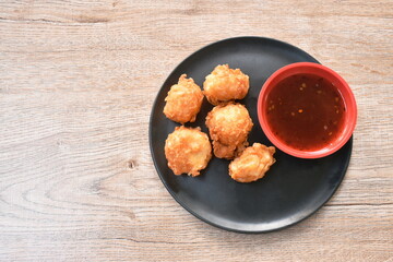 crispy fried squid ball dipping spicy and sweet sauce on plate