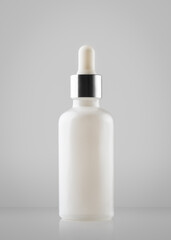 glass serum bottle mockup, cosmetic product isolated on a neutral grey background, template