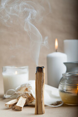 Palo Santo bars close-up and copy space. Ritual cleansing with sacred ibiocai, meditation, aromatherapy with incense and candles.. - obrazy, fototapety, plakaty