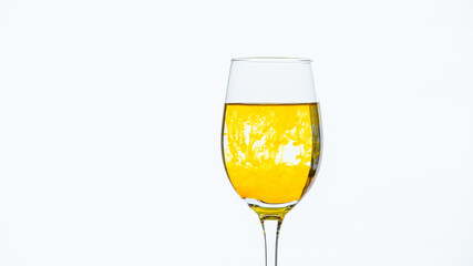 Yellow ink drips into the glass with water and creates beautiful colored lines.
