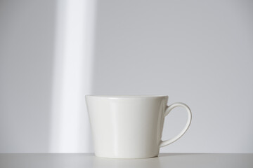 white cup on white background with ray