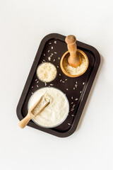 Pestle rice flour - grains with mortar on kitchen table