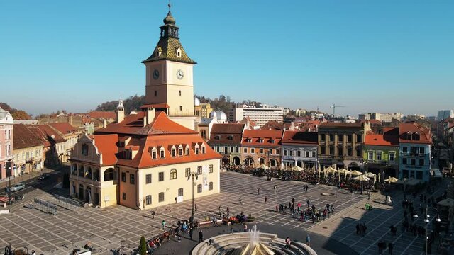 Aerial drone view of The Council Square in Brasov, Romania. Old city centre with County Museum of History, buildings, people