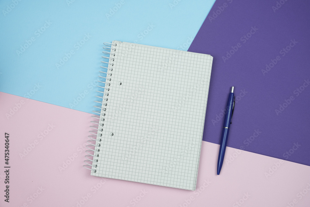 Poster empty paper and pen on colored paper background with copy space