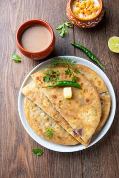 Paneer paratha is a popular North Indian flatbread made with whole wheat flour dough and stuffed with savory, spiced, grated paneer