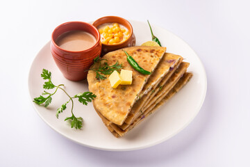 Paneer paratha is a popular North Indian flatbread made with whole wheat flour dough and stuffed with savory, spiced, grated paneer