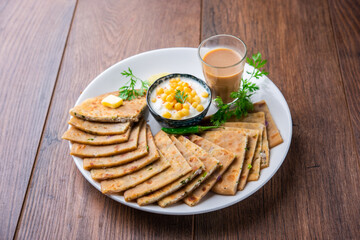 Paneer paratha is a popular North Indian flatbread made with whole wheat flour dough and stuffed with savory, spiced, grated paneer