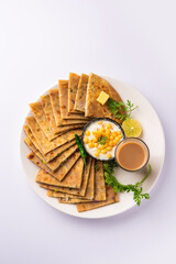 Paneer paratha is a popular North Indian flatbread made with whole wheat flour dough and stuffed with savory, spiced, grated paneer