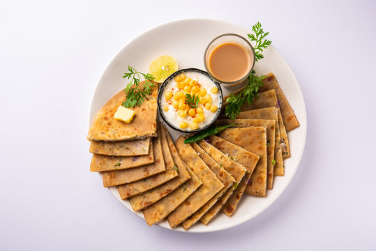 Paneer paratha is a popular North Indian flatbread made with whole wheat flour dough and stuffed with savory, spiced, grated paneer