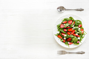 Fresh fruit salad with spinach and strawberry. Healthy happy meal