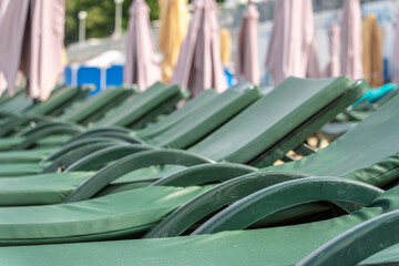 A row of sun loungers on the beach.