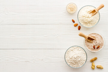 Fototapeta na wymiar Bowls of various gluten free flour - almond peanut oat and rice buckwheat flour