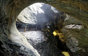 Beautiful scene of a mysterious cave sculptured by Trummelbach Waterfall (Trummelbachfalle) in...