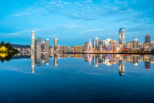 cityscape and skyline of downtown near water of chongqing at night