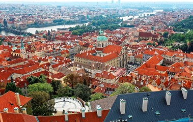 View from top of the South Tower of St. Vitus Cathedral in Prague Castle with   Vltava River & red rooftops in Old Town Prague, Czech Republic