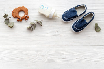Baby newborn accessories with blue booties bootle of milk and toy