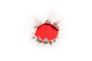 Naklejka na ściany i meble A hole in a white paper on a red background.