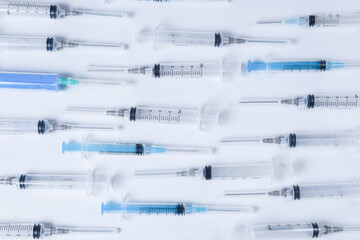 Many medical syringes as a background.